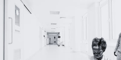 Black and white image with a young girl in a hospital