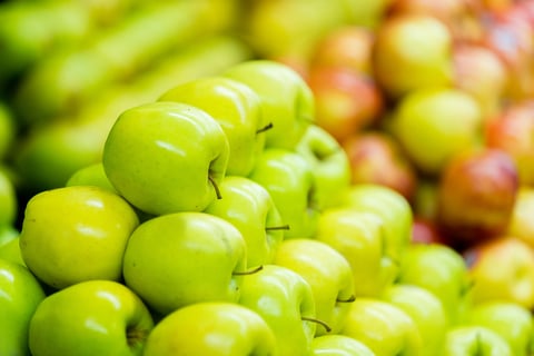 Pile of fresh green apples at the supermarket