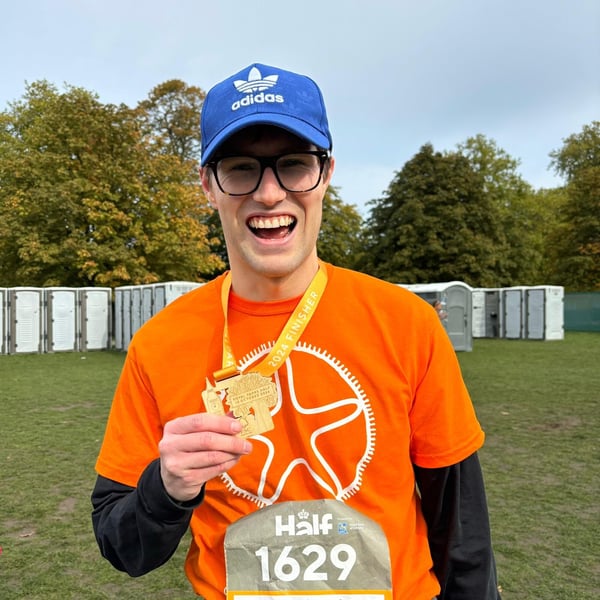 Person in a Starfish shirt holding a medal